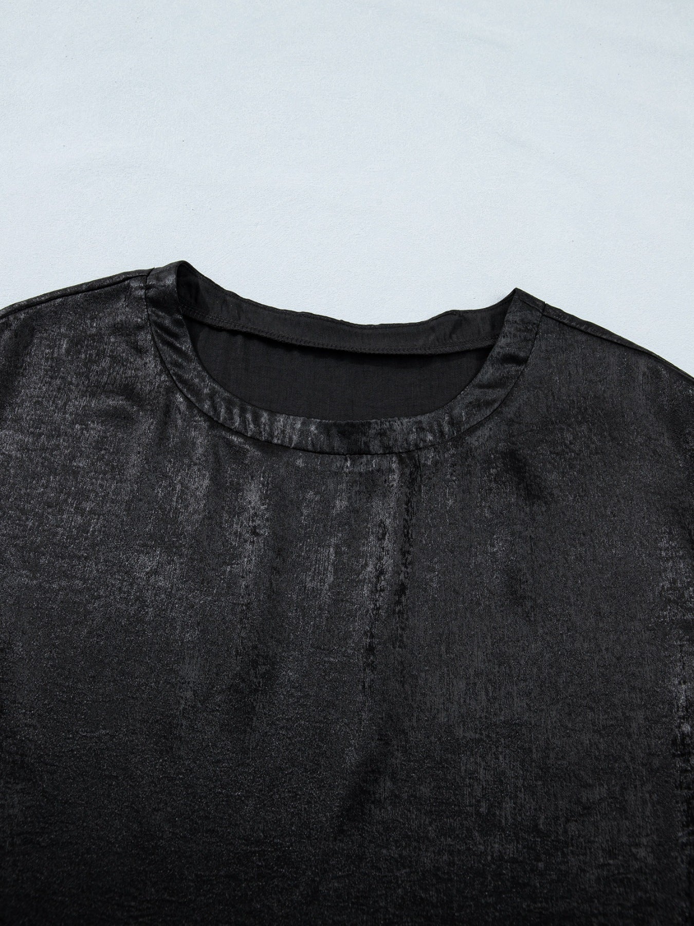 Black metallic tee with round neck and cap sleeves, made of polyester and spandex blend.