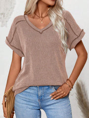 Pink ribbed V-neck t-shirt with contrast stitching and short sleeves.