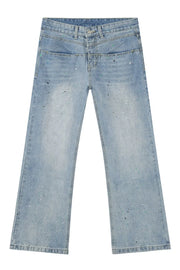 Light wash denim jeans with double waistline and splatter paint detail.