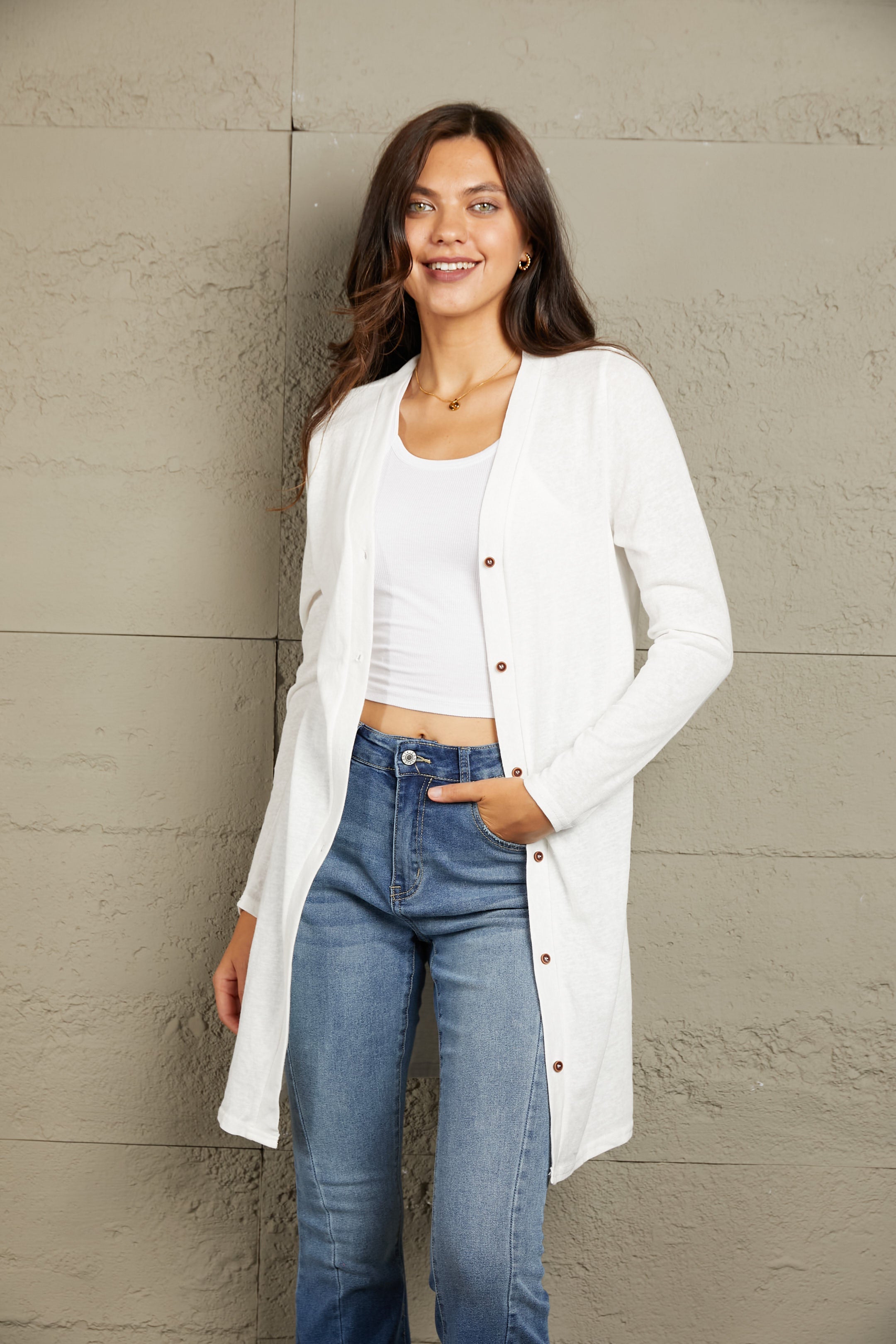 White button-down maxi cardigan with long sleeves and a relaxed fit.
