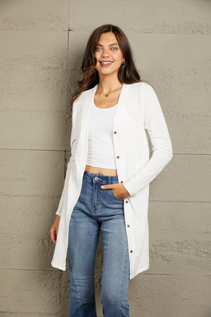 White button-down maxi cardigan with long sleeves and a relaxed fit.