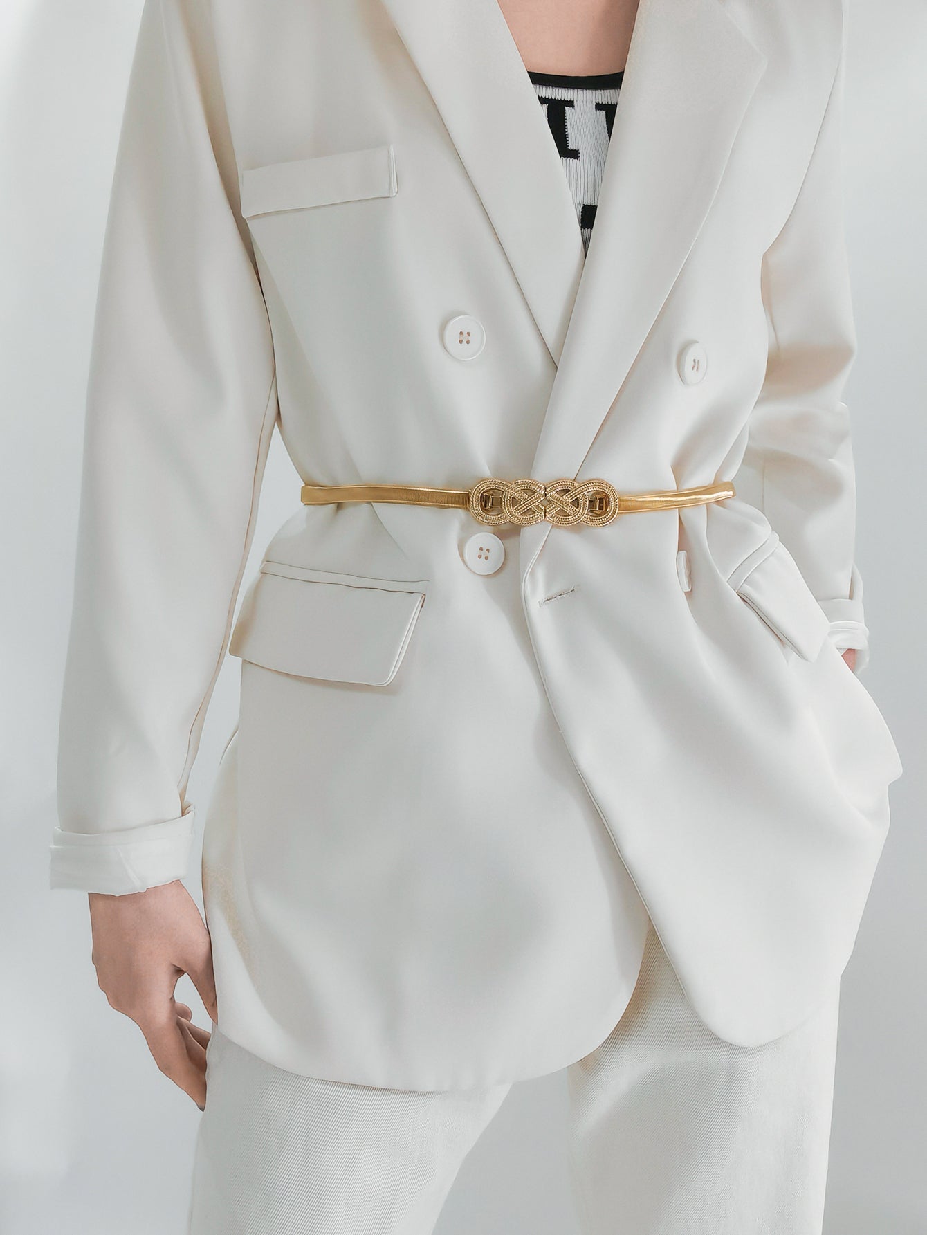 Gold intertwined knot metal waist belt with a textured buckle detail.