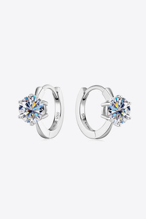 Silver moissanite solitaire huggie hoop earrings with sparkling round-cut stones.