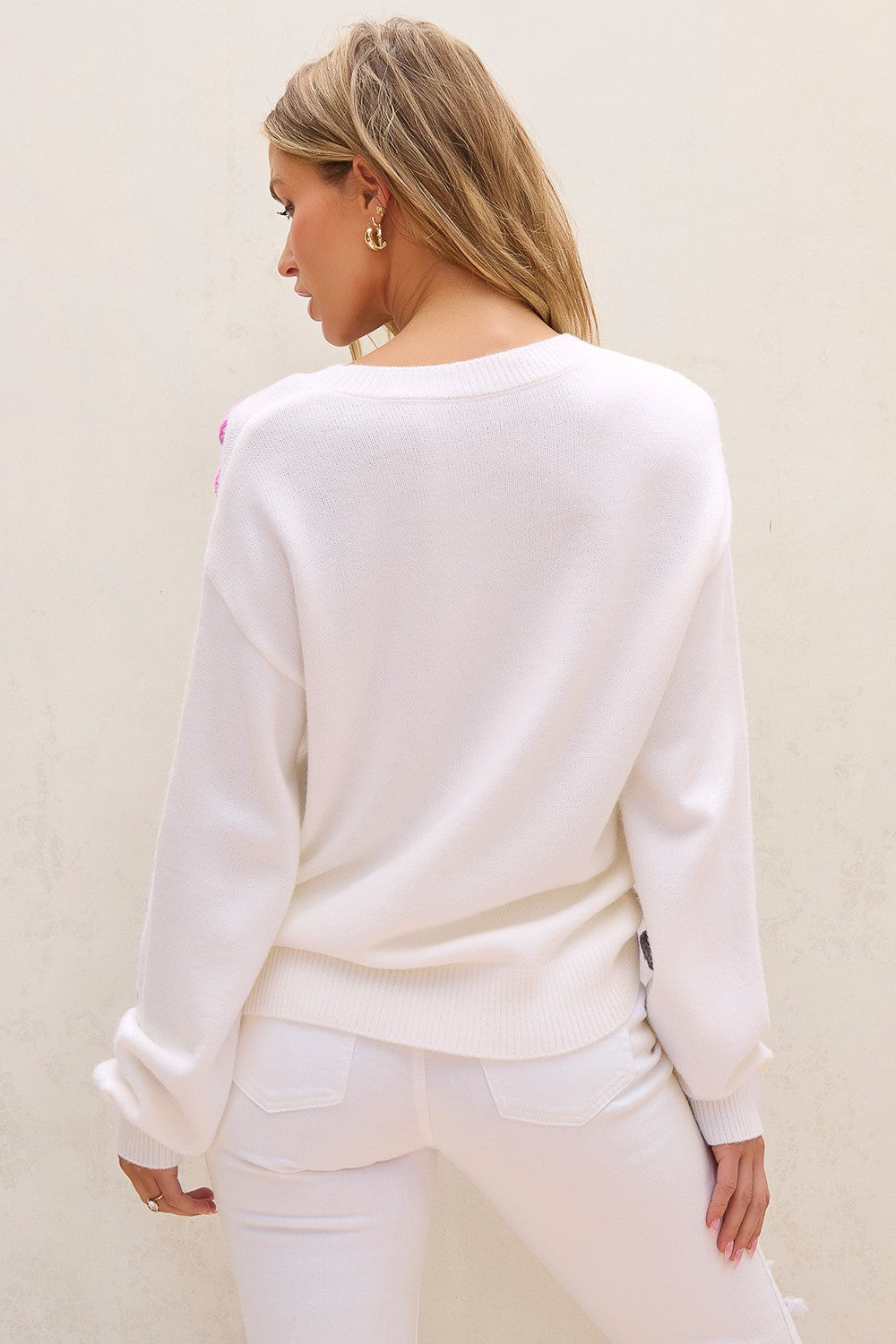 White acrylic sweater with embroidered floral detail on shoulder, crew neck, long sleeves.