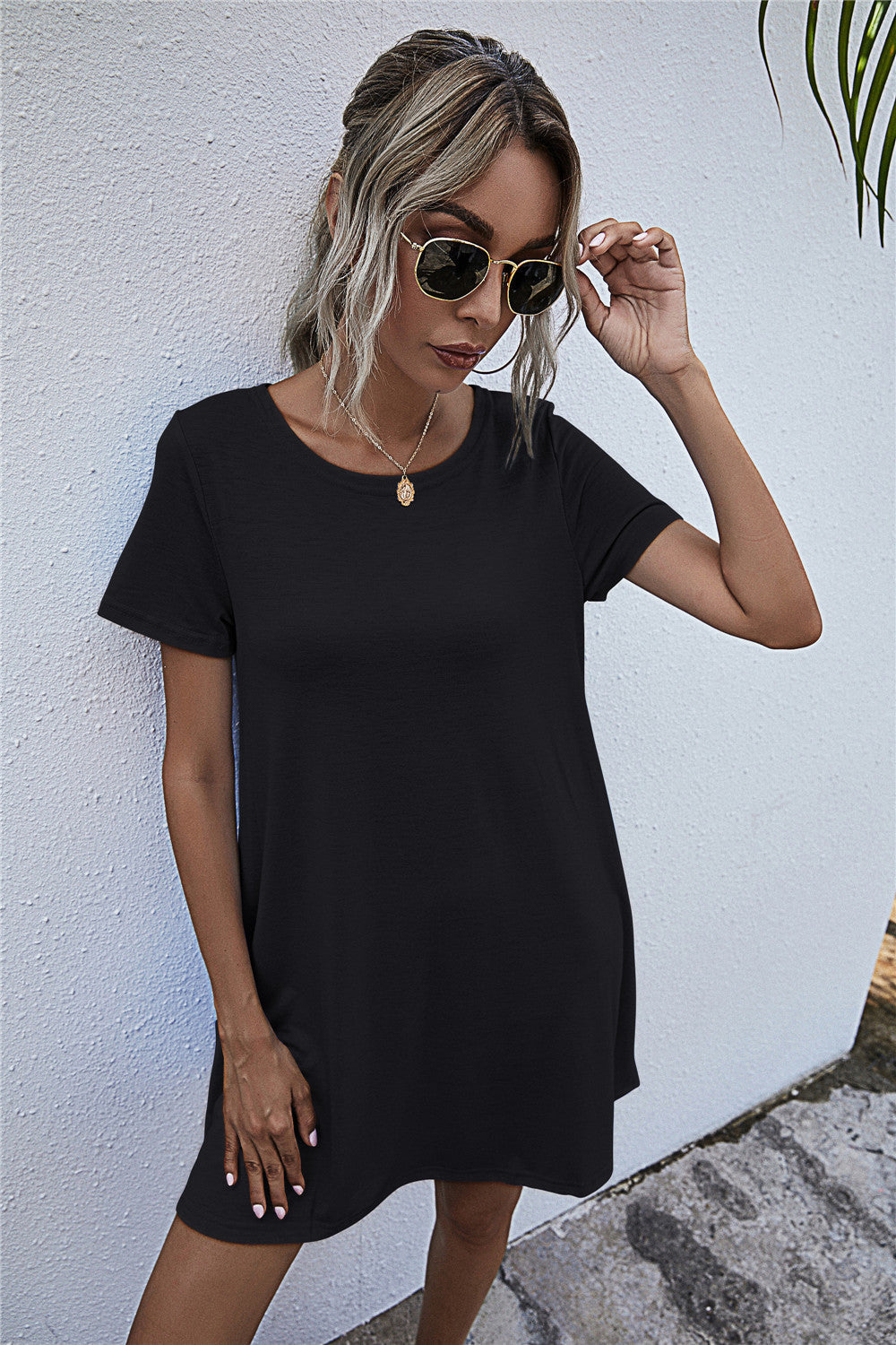 Black relaxed tee dress with short sleeves and crew neck, featuring side pockets.