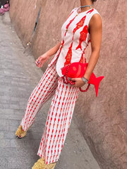 Red fish print sleeveless top and wide-leg pants set with gold button details.