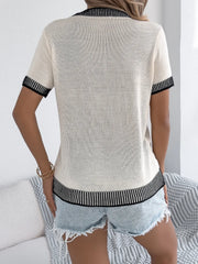 Cream knit tee with black contrast trim on collar, sleeves, and hem.