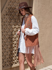 Terracotta faux suede vest with embroidered leaf detail and long fringe.