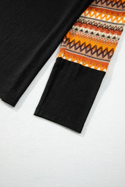 Black raglan tee with Aztec patterned sleeves in tangerine and brown.