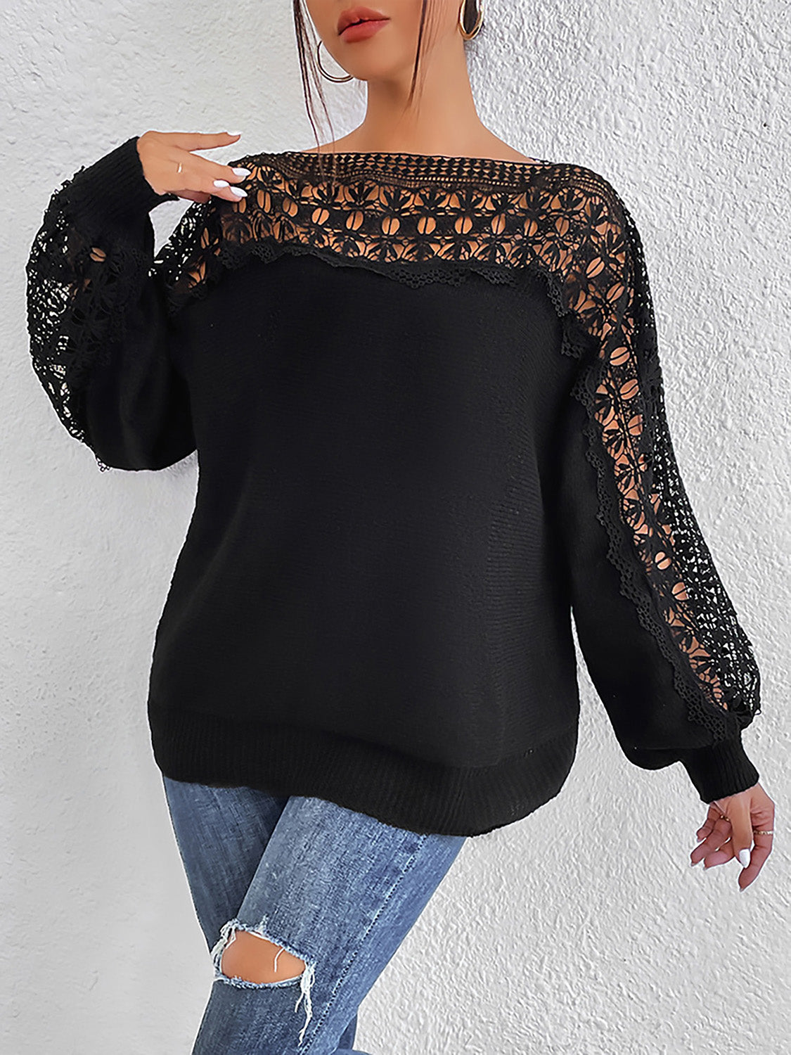 Black acrylic sweater with boatneck, balloon sleeves, and lace inset details.