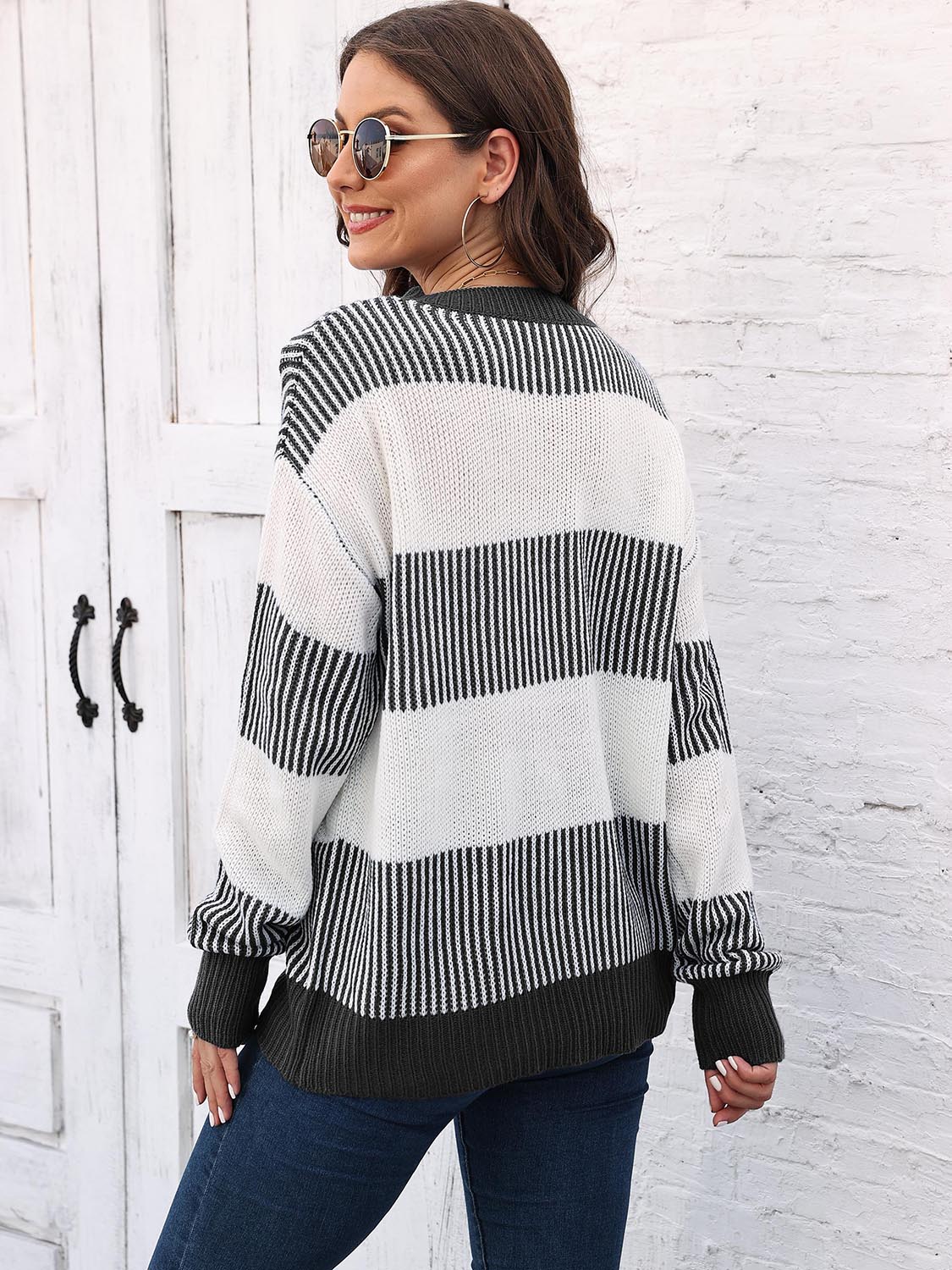 Striped knit crewneck sweater with ribbed trim in black and white acrylic.