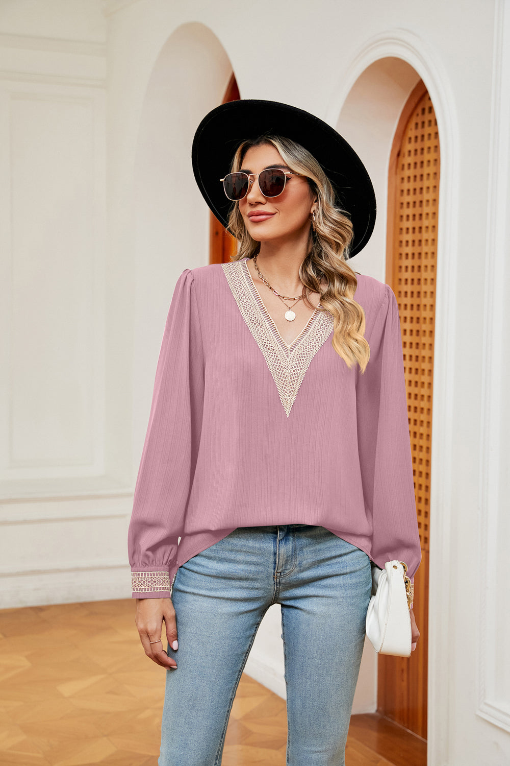Blush pink blouson top with V-neck lace trim and long sleeves.
