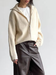 Cream ribbed knit zipper cardigan with a high collar, styled with a white tee and dark pants.