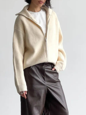 Cream ribbed knit zipper cardigan with a high collar, styled with a white tee and dark pants.