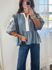 Blue embroidered peplum blouse with V-neck and elbow sleeves