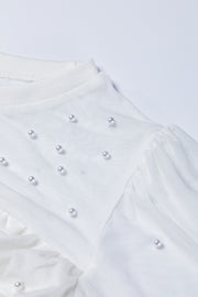 White mesh bodysuit with pearl embellishments and ruched detail
