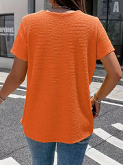 Orange textured short sleeve blouse with a crew neck.
