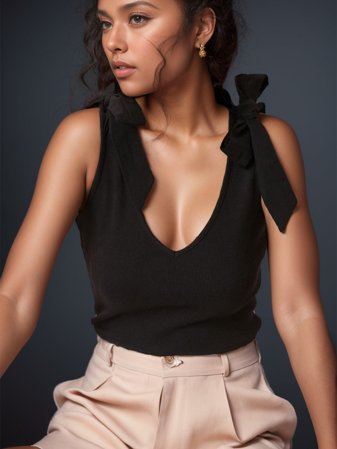 Black ribbed knit tank top with bow shoulder details and a V-neckline