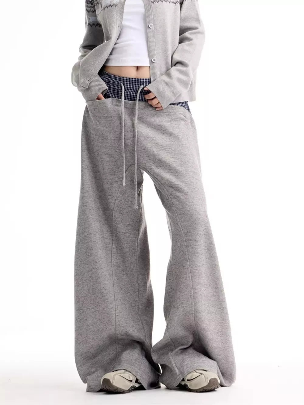 Grey wide-leg sweatpants with drawstring and pockets, styled with a cropped cardigan.