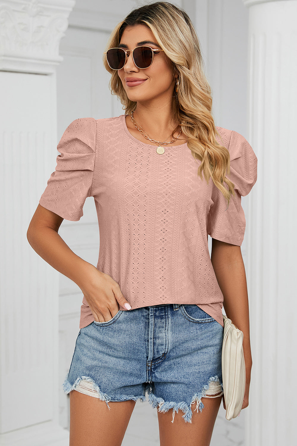 Perforated puff sleeve top in blush pink with a textured diamond pattern and crew neck.