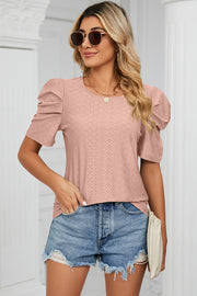 Perforated puff sleeve top in blush pink with a textured diamond pattern and crew neck.