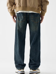 Loose fit blue cotton denim jeans with vintage wash and distressed details.