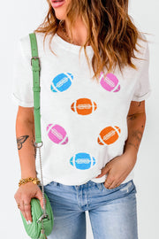 White t-shirt with rolled sleeves and scattered colorful football graphics.