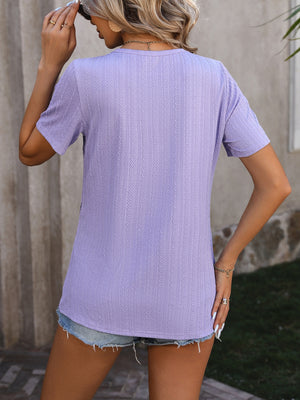 Lavender textured tee with short sleeves and a split hem detail.