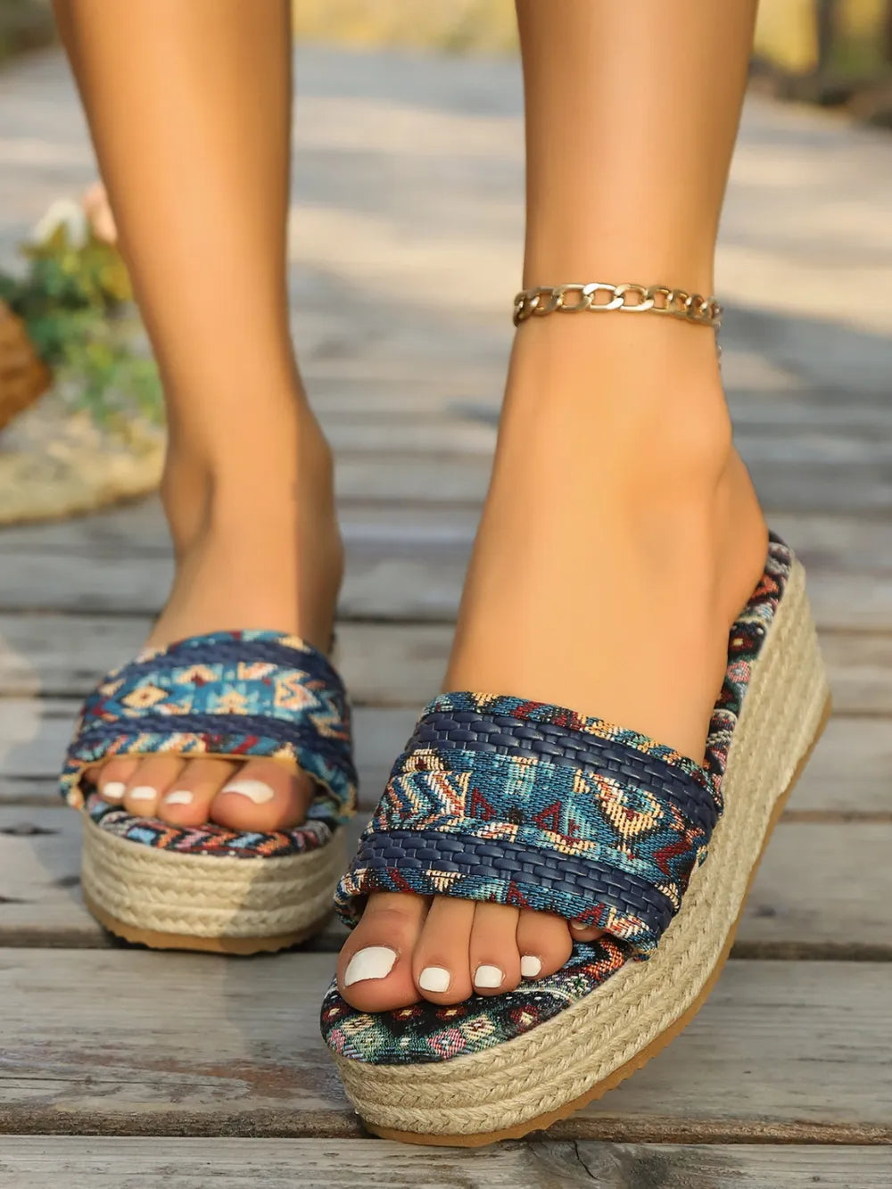 Woven platform slides in dark navy with geometric detail and espadrille sole.