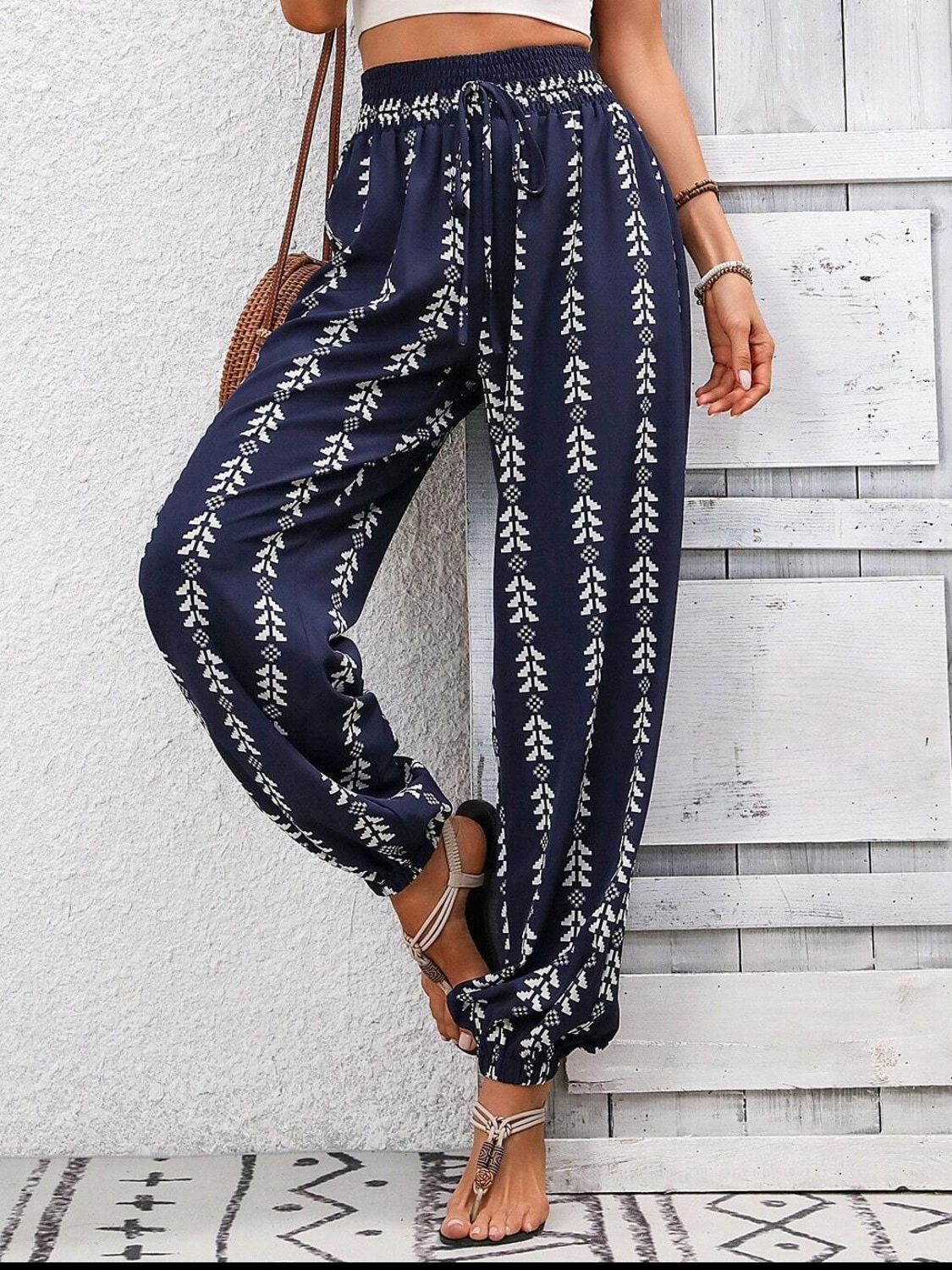 Dark Blue ankle trousers with white leaf print, drawstring waist, and gathered ankles.