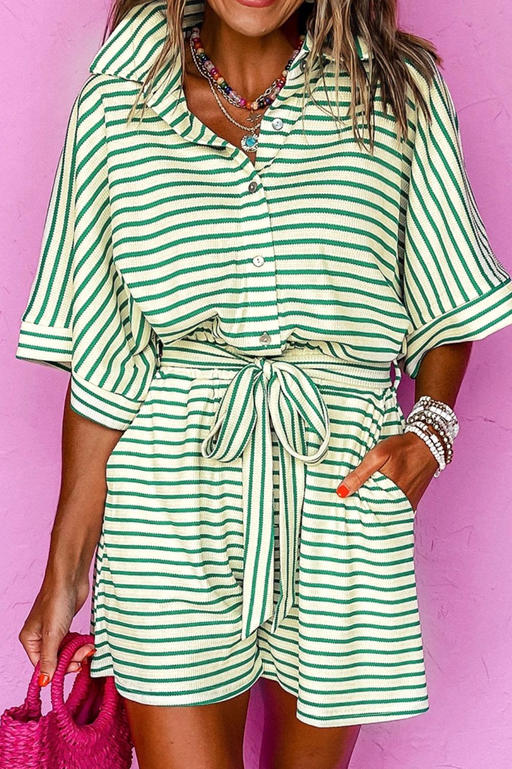 Striped green and cream resort shirt romper with tie waist and button front.