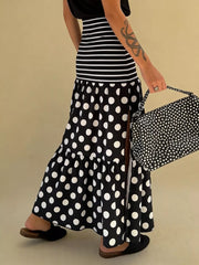 Black polka dot maxi skirt with a high slit and tiered ruffle hem.