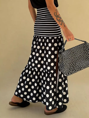 Black polka dot maxi skirt with a high slit and tiered ruffle hem.