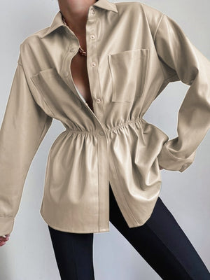 Tan faux leather shirt jacket with gathered waist and chest pockets