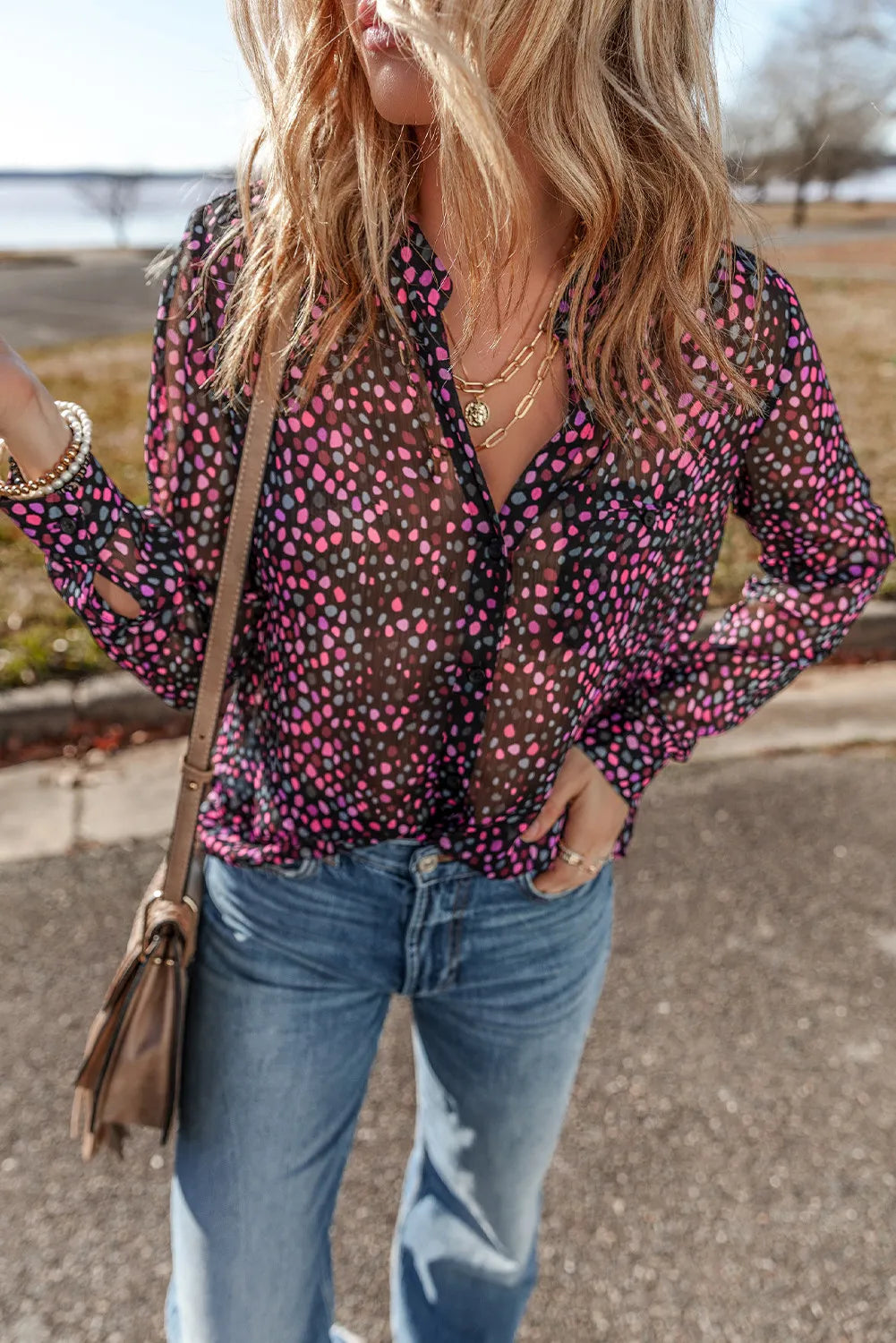 Dotted sheer black blouse with knot detail and split sleeves.