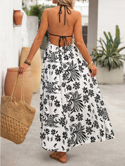 Maxi dress with black floral print, halter neck, and open back.