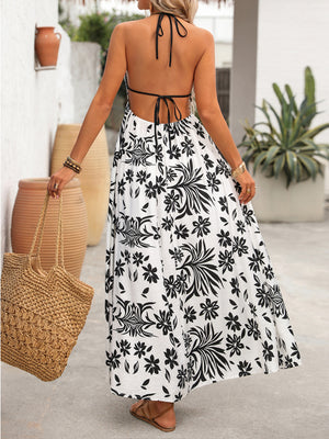 Maxi dress with black floral print, halter neck, and open back.