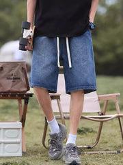 Relaxed fit blue denim shorts with white drawstring detail