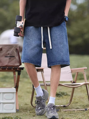 Relaxed fit blue denim shorts with white drawstring detail