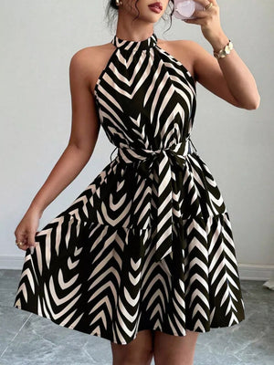Black halter neck tie-waist ruffle dress with a bold chevron print.
