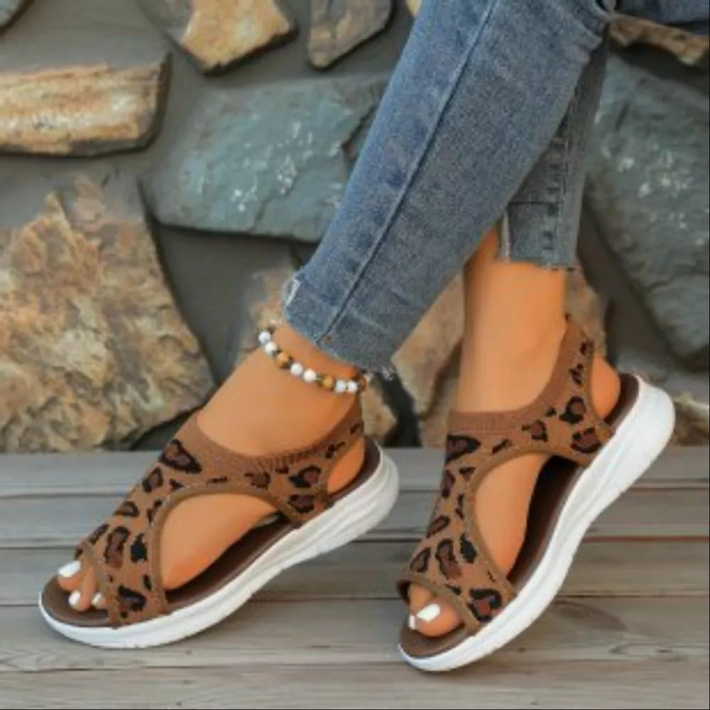 Leopard print open-toe platform sandals with white soles and brown trim.