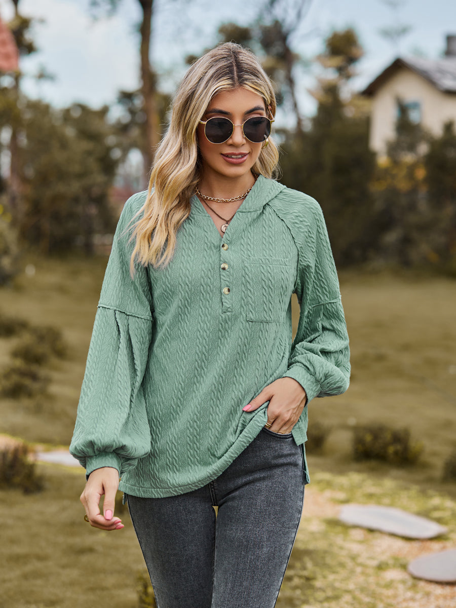 Textured knit henley in Gum Leaf with balloon sleeves and buttoned neckline.