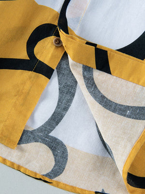 Men's cotton button-up shirt with abstract yellow, black, and white pattern.