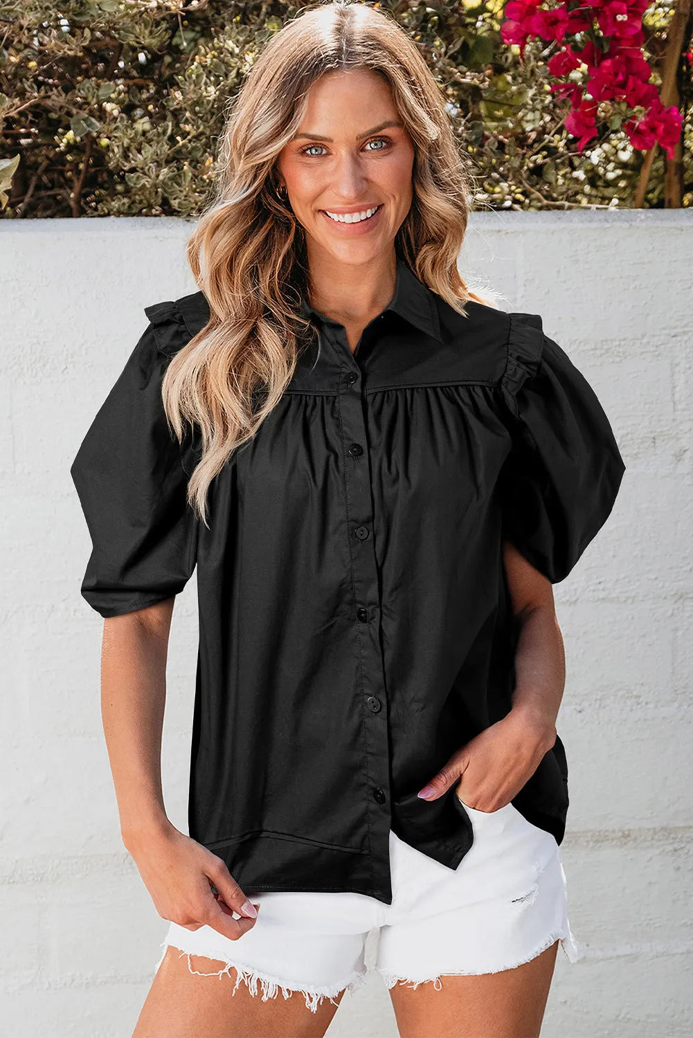 Black poplin blouse with gathered detail and puff sleeves, button front, collared neckline.