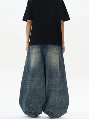 Oversized vintage-finish men's baggy jeans in distressed blue denim with a wide leg
