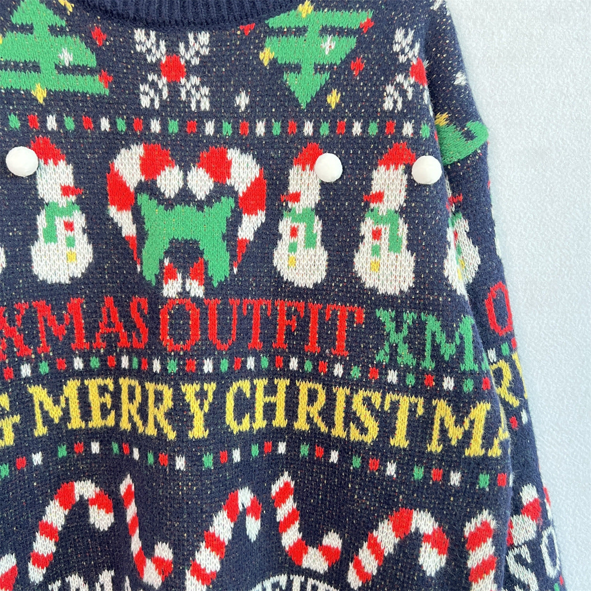 Dark blue acrylic knit sweater with Christmas graphics, snowmen, candy canes, and text.