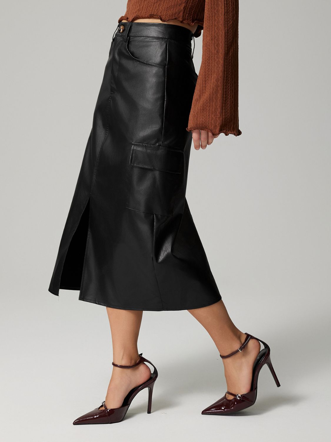Black faux leather midi skirt with cargo pockets and side slit