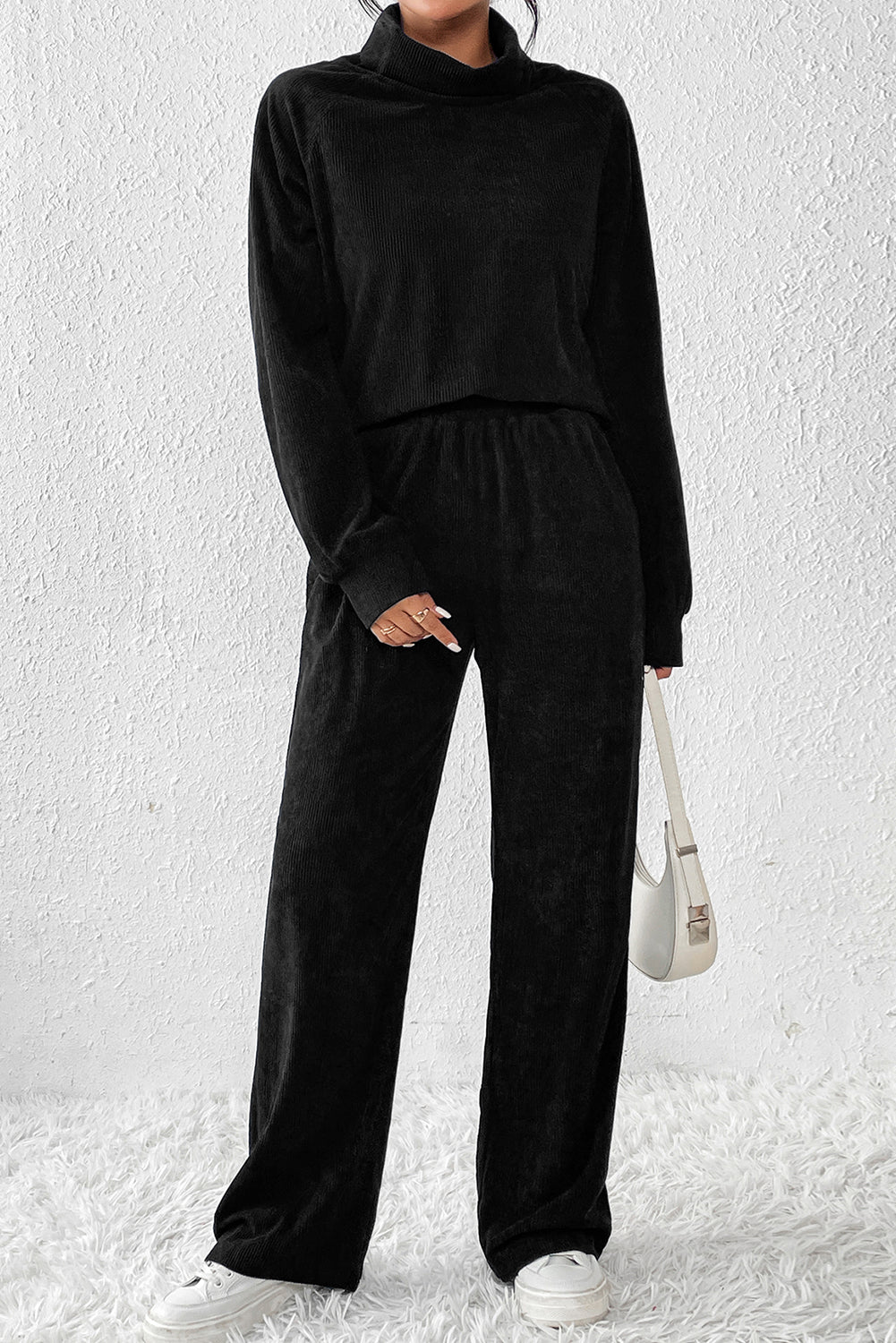 Black corduroy turtleneck lounge set with wide-leg pants and long sleeves.