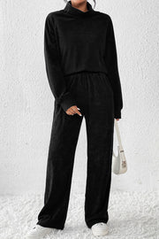 Black corduroy turtleneck lounge set with wide-leg pants and long sleeves.