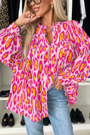 Pink leopard print blouse with balloon sleeves and button front